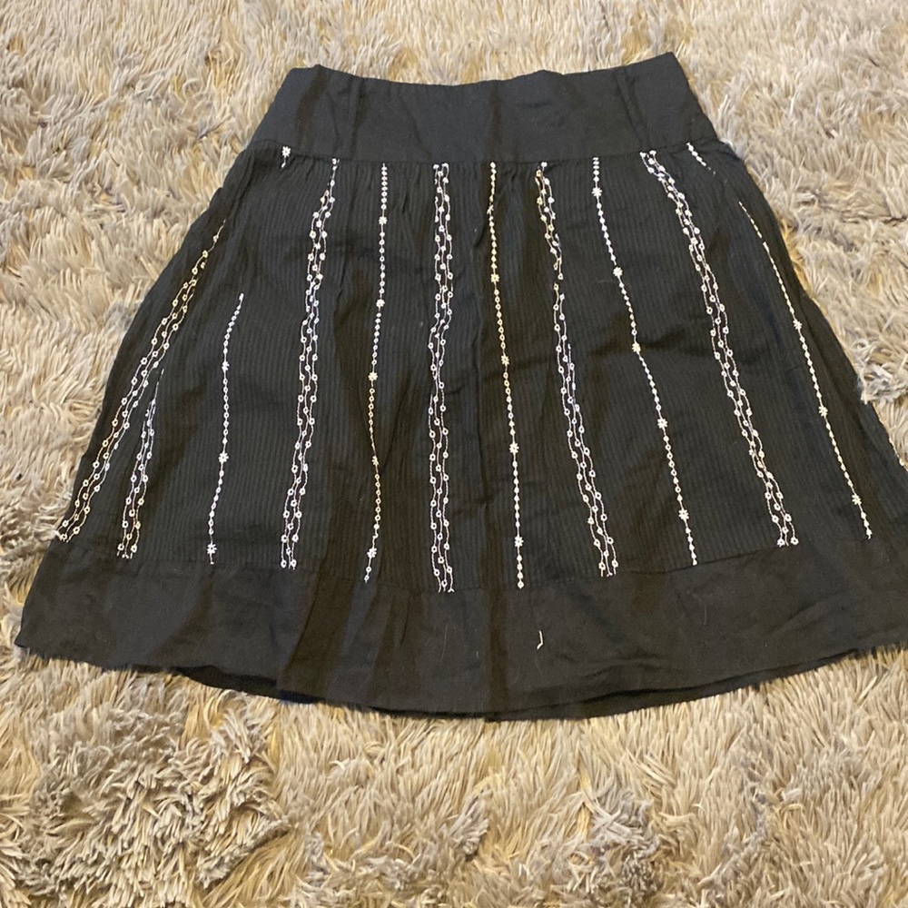 Black with white embroidery skirt.